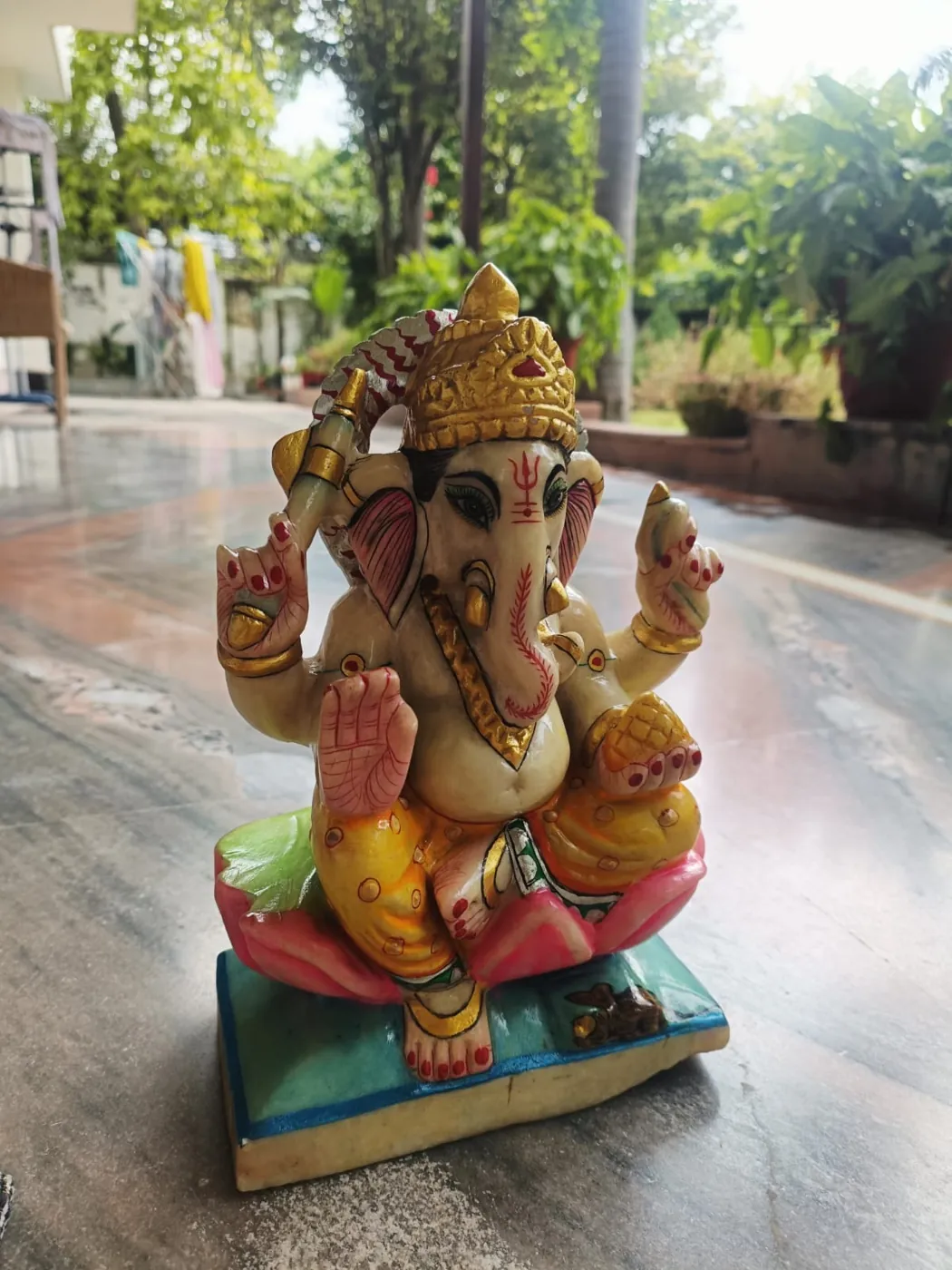 Marble Ganesh ji murti on a red base