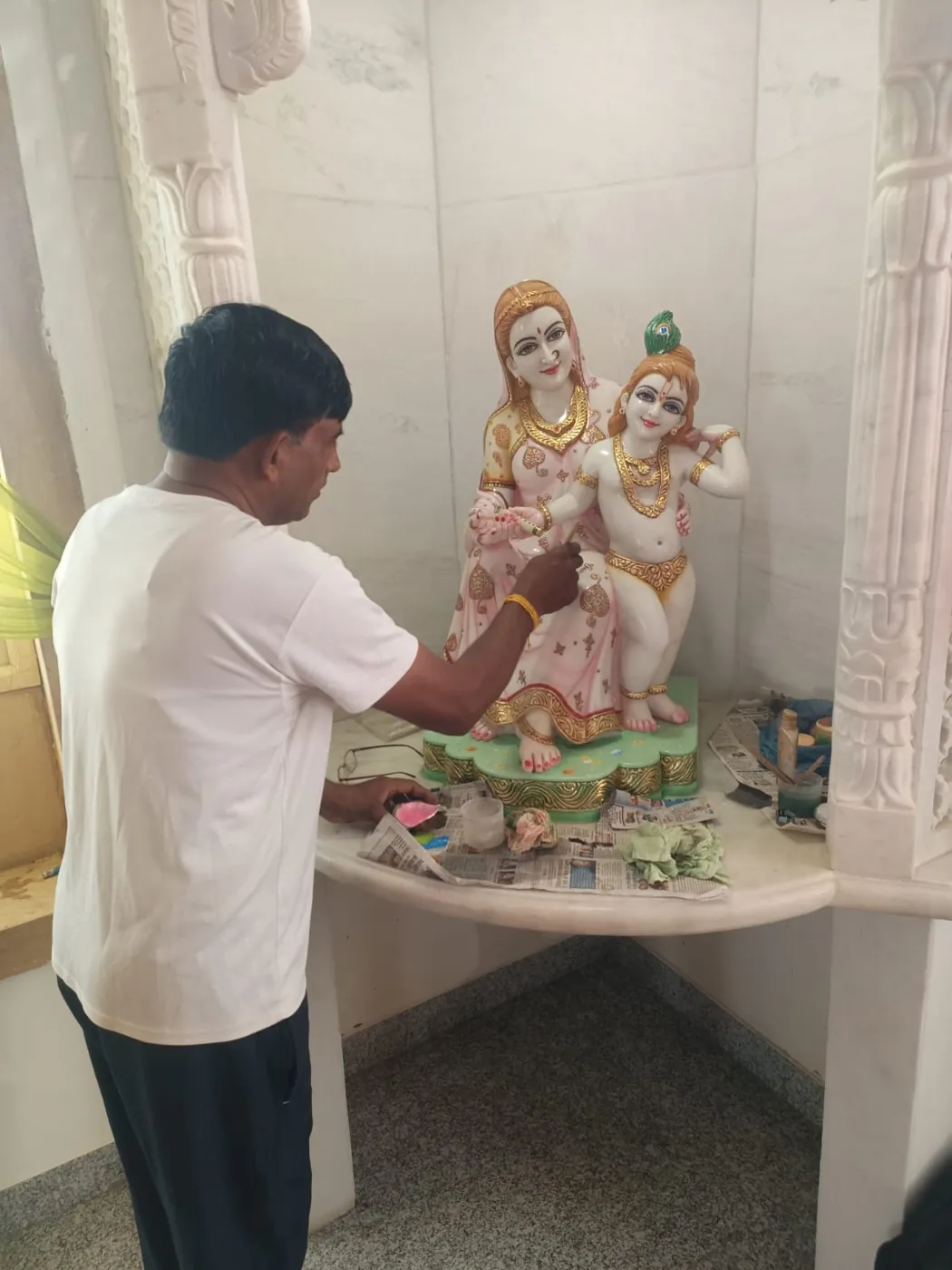 Artisan working on a Radha Krishna marble murti at the workshop