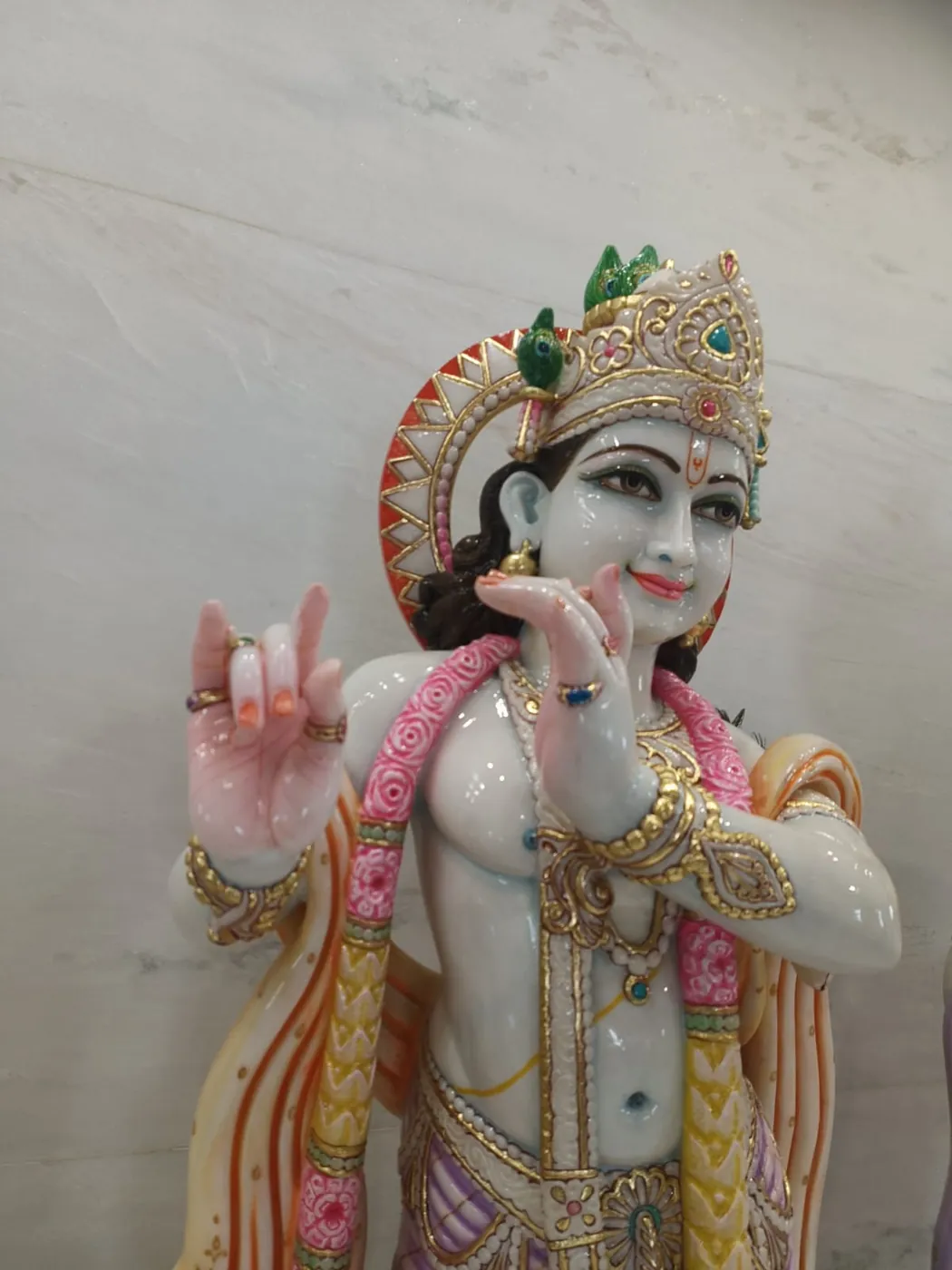 Handcrafted marble Krishna murti face detailing for a home temple